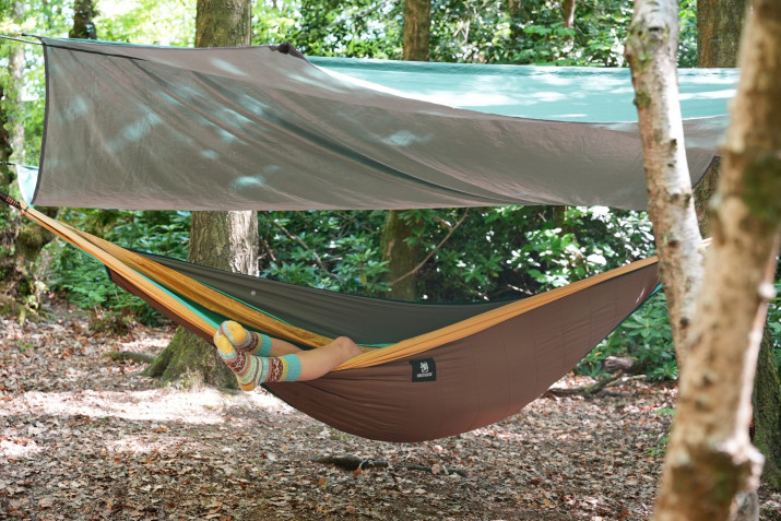 Person laying in a hammock in the woods